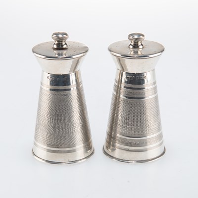 Lot 1206 - A PAIR OF ELIZABETH II ENGINE-TURNED SILVER PEPPER GRINDERS