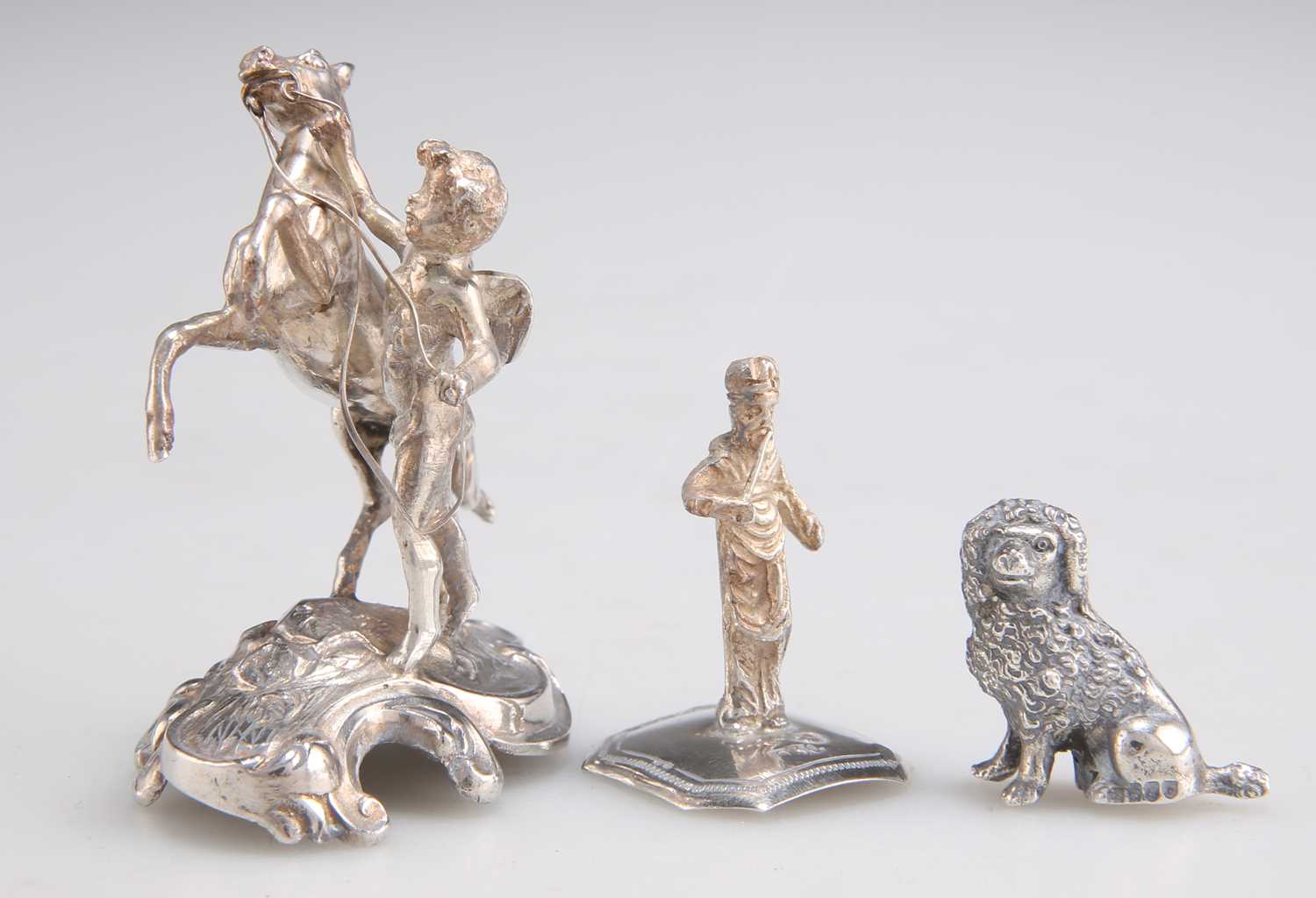 Lot 1102 - THREE MINIATURE SILVER IMPORT FIGURES