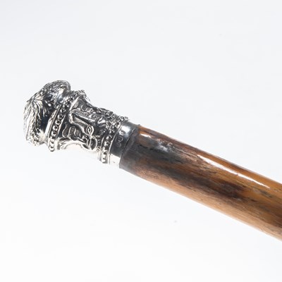 Lot 1272 - A CARVED BAMBOO CANE WITH SILVER TOP