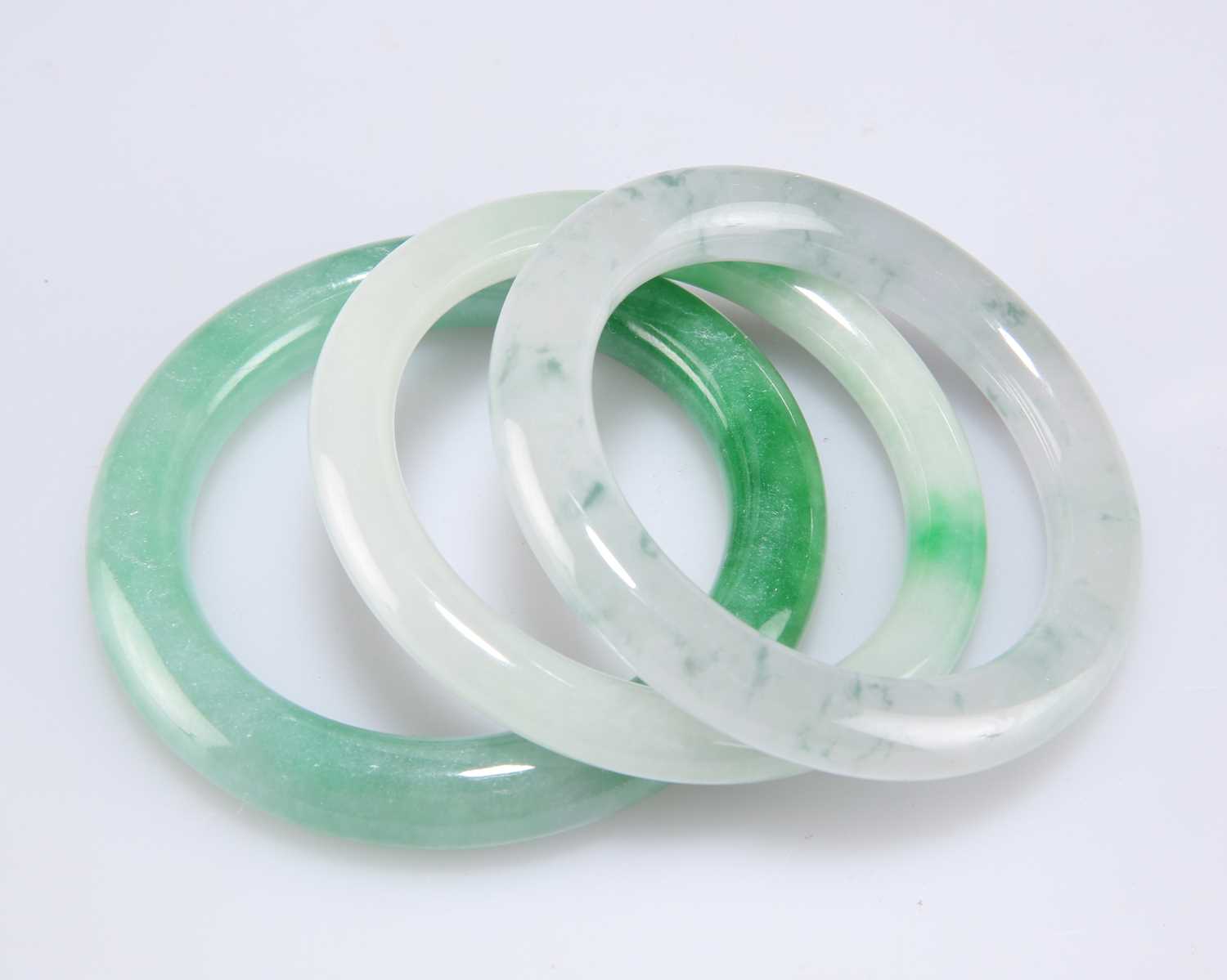 Lot 214 - THREE CHINESE JADE BANGLES