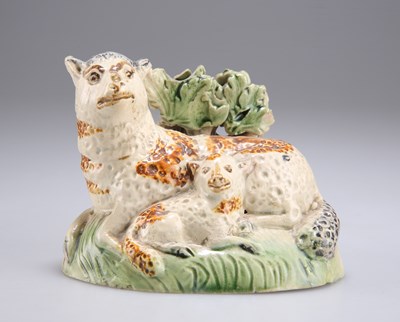 Lot 52 - AN EARLY 19TH CENTURY YORKSHIRE POTTERY MODEL OF A EWE AND LAMB