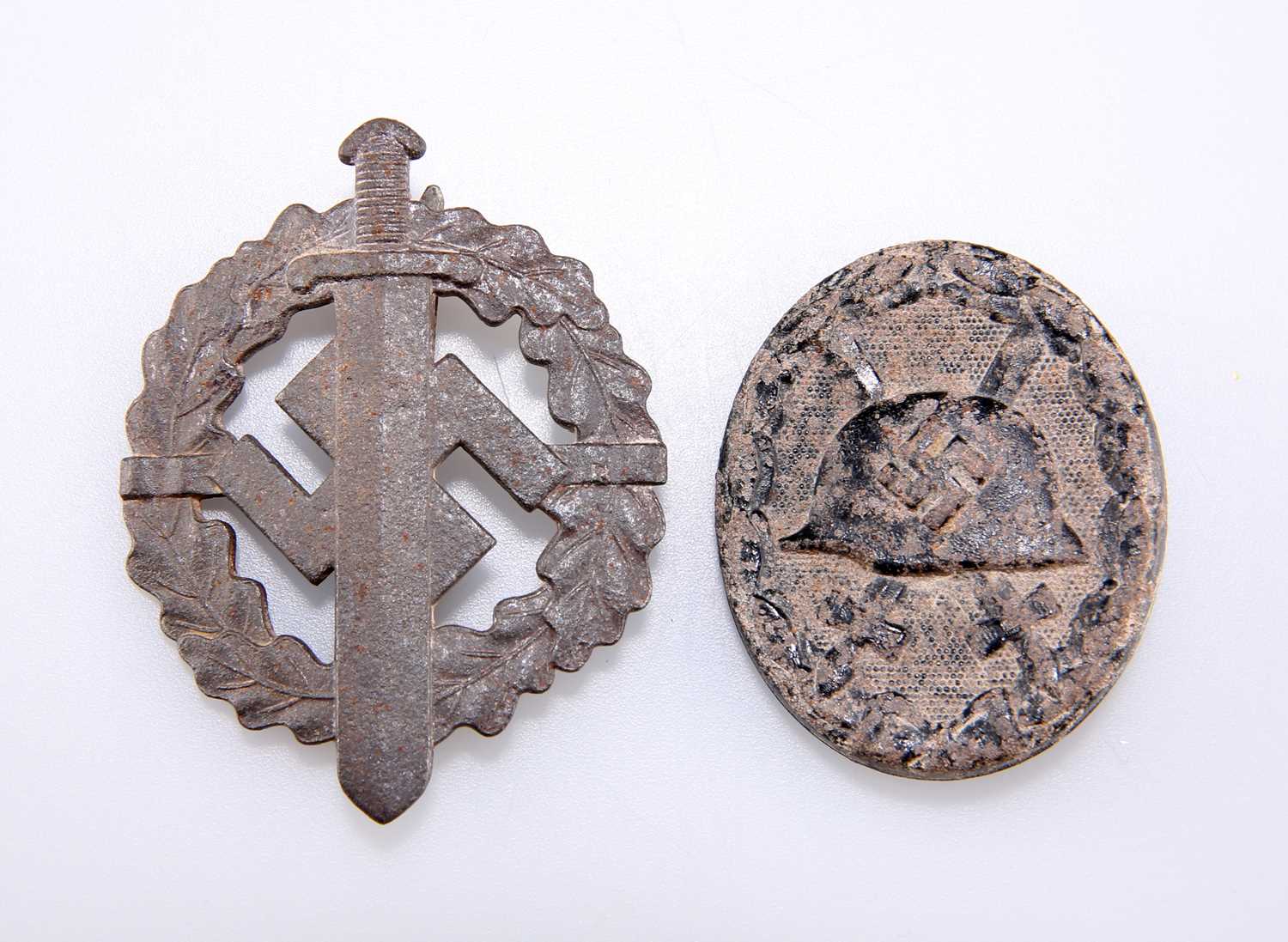 Lot 469 - A WW2 THIRD REICH WOUND BADGE, AND AN IRON SA SPORTS BADGE