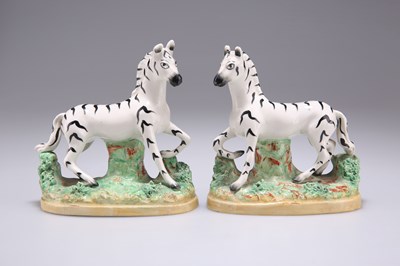 Lot 56 - A PAIR OF 19TH CENTURY STAFFORDSHIRE POTTERY ZEBRAS