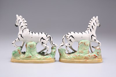 Lot 56 - A PAIR OF 19TH CENTURY STAFFORDSHIRE POTTERY ZEBRAS