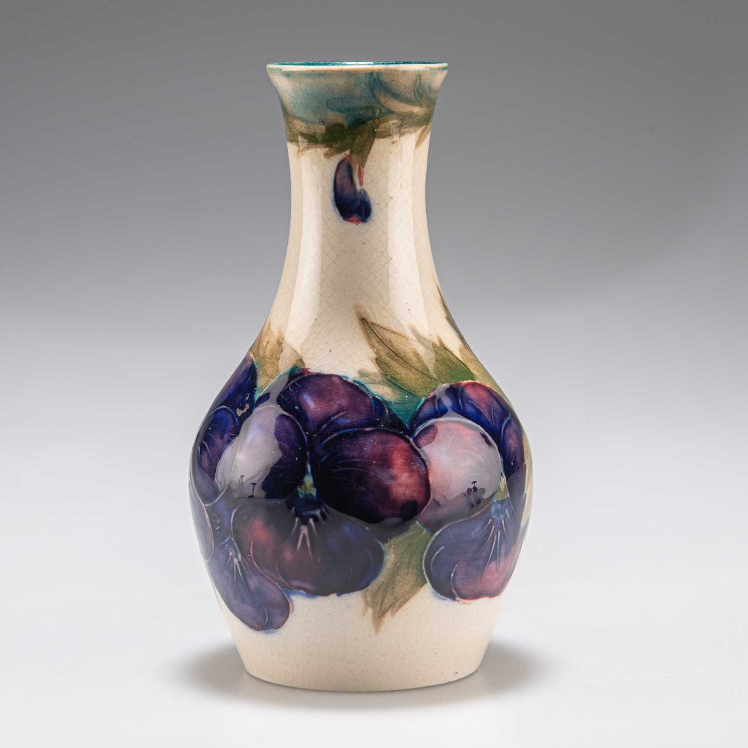 Lot 177 - A WILLIAM MOORCROFT BURSLEM 'PANSY' PATTERN POTTERY VASE