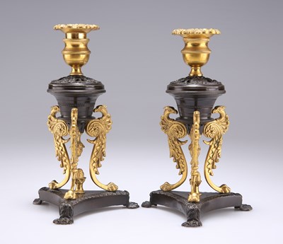 Lot 310 - A PAIR OF REGENCY PATINATED AND GILT BRONZE DWARF CANDLESTICKS, IN THE MANNER OF CHENEY, LONDON