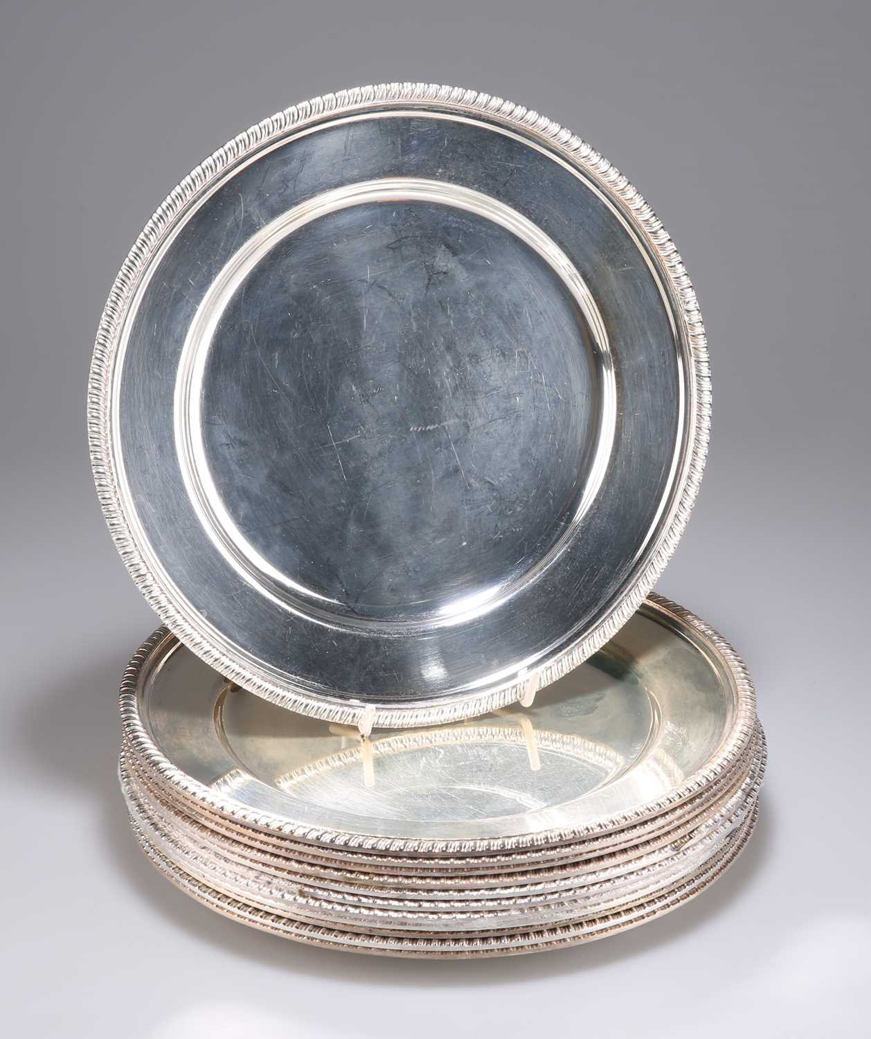 Lot 1132 - A SET OF TWELVE SILVER-PLATED DINNER PLATES, CIRCA 1900