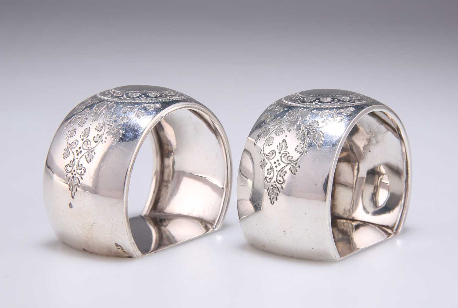 Lot 1447 - A PAIR OF VICTORIAN ENGRAVED SILVER NAPKIN RINGS