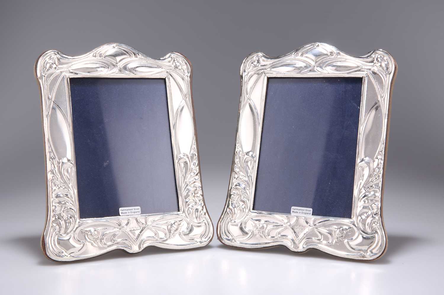Lot 1149 - A PAIR OF ART NOUVEAU STYLE SILVER PHOTOGRAPH FRAMES
