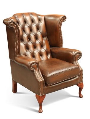 Lot 636 - A BROWN LEATHER CHESTERFIELD WING-BACK ARMCHAIR