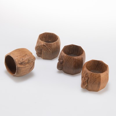 Lot 794 - ROBERT THOMPSON OF KILBURN, A SET OF FOUR MOUSEMAN OAK NAPKIN RINGS