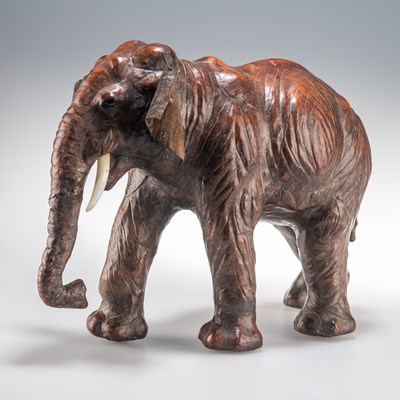 Lot 448 - A 20TH CENTURY LIBERTY STYLE LEATHER CLAD MODEL OF AN INDIAN ELEPHANT