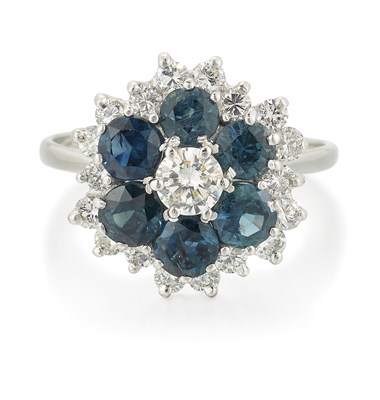 Lot 2463 - AN 18 CARAT WHITE GOLD SAPPHIRE AND DIAMOND CLUSTER RING