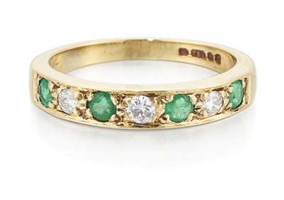 Lot 2390 - AN 18 CARAT GOLD EMERALD AND DIAMOND HALF HOOP RING