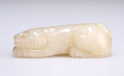 Lot 636 - A CHINESE JADE CARVING OF A PROSTRATE LION DOG