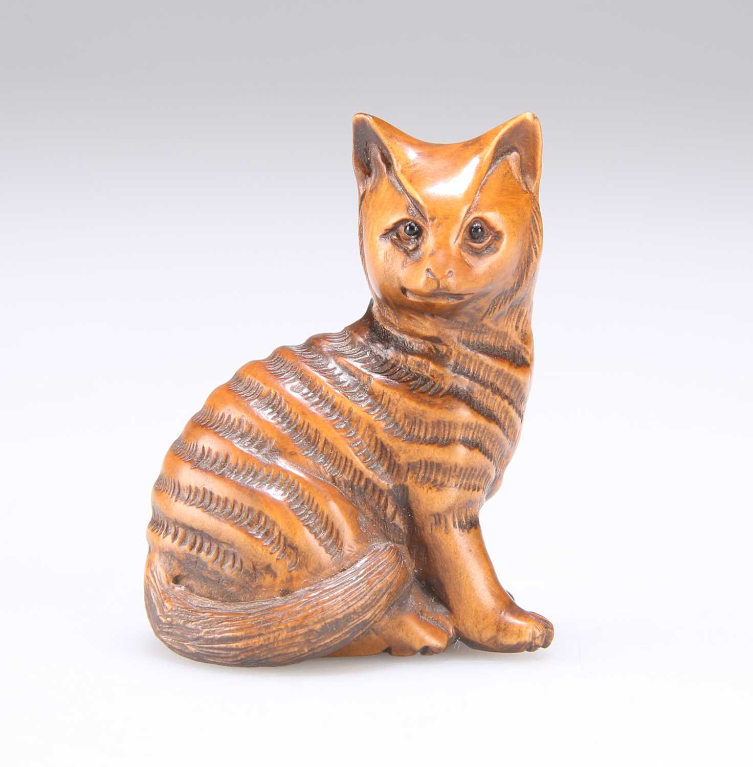 Lot 633 - A JAPANESE CARVED WOOD CAT NETSUKE