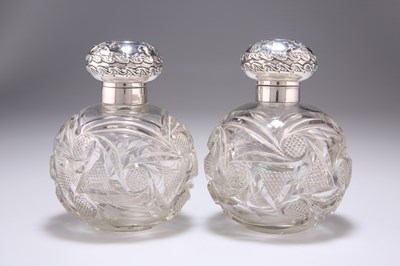 Lot 155 - A PAIR OF EDWARDIAN SILVER-MOUNTED DRESSING TABLE JARS